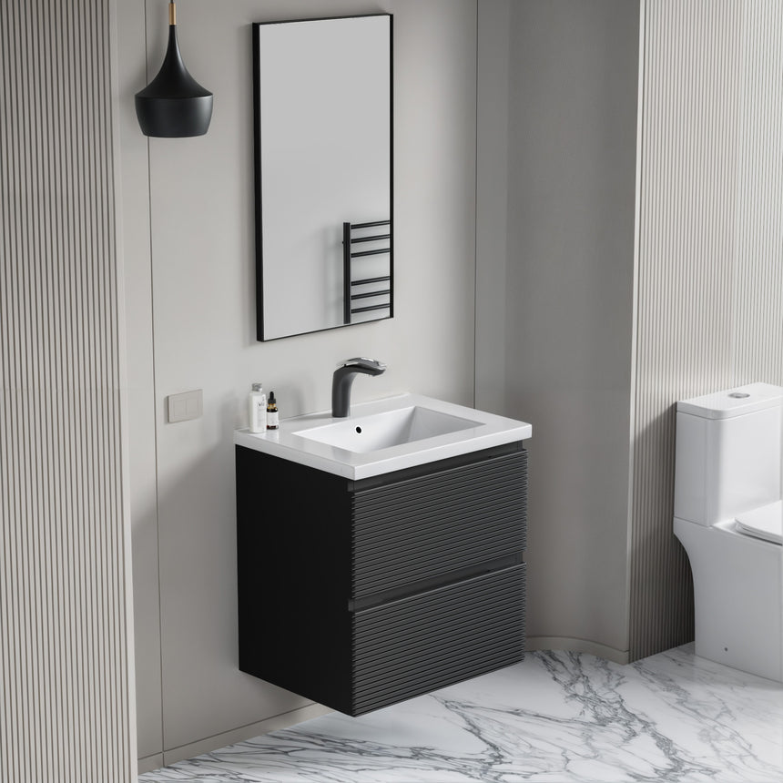 Bathroom vanity with wooden finish and white countertop against a gray wall.