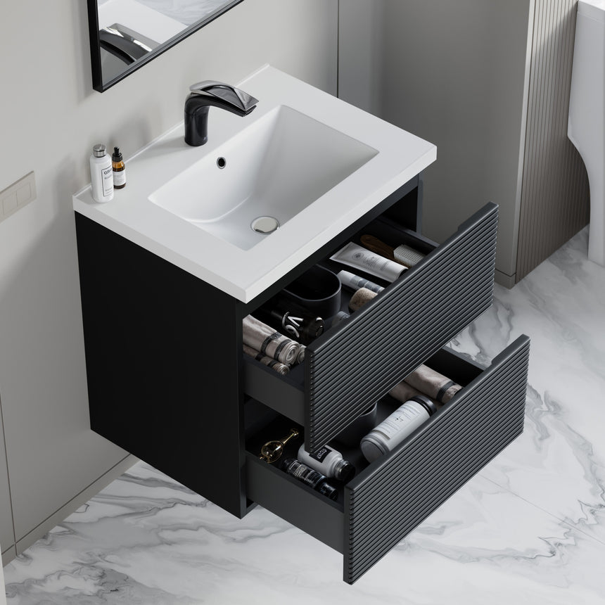 Bathroom vanity with wooden finish and white countertop against a gray wall.