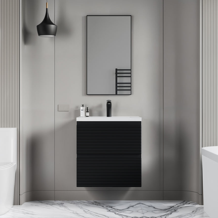 Bathroom vanity with wooden finish and white countertop against a gray wall.
