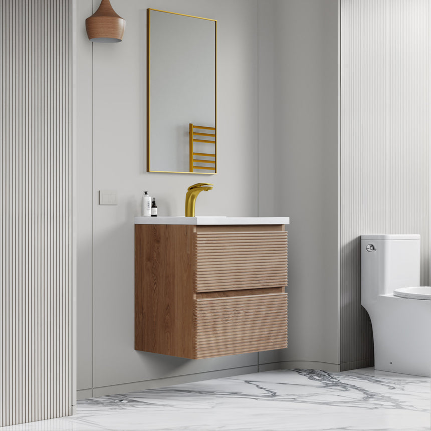 Bathroom vanity with wooden finish and white countertop against a gray wall.