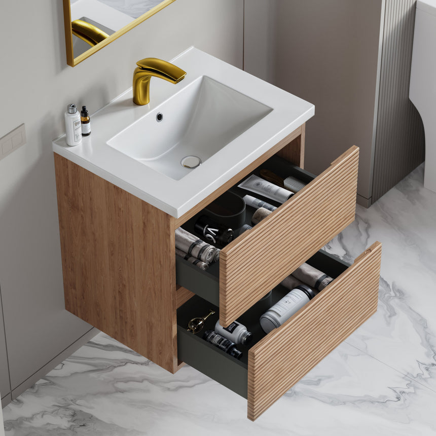 Bathroom vanity with wooden finish and white countertop against a gray wall.