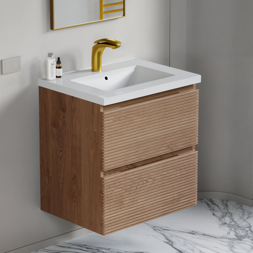 Bathroom vanity with wooden finish and white countertop against a gray wall.