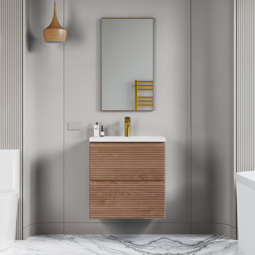 Bathroom vanity with wooden finish and white countertop against a gray wall.