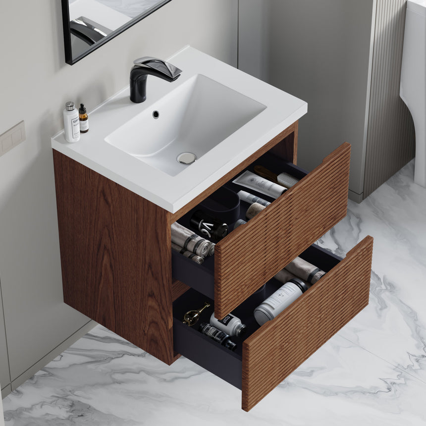 Bathroom vanity with wooden finish and white countertop against a gray wall.