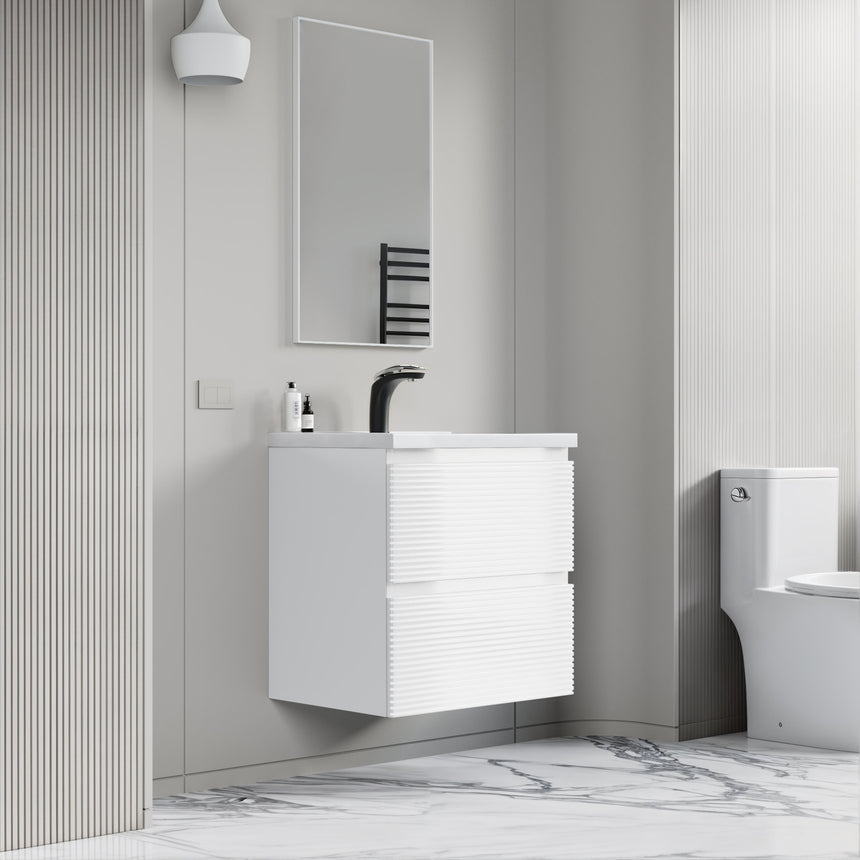 Bathroom vanity with wooden finish and white countertop against a gray wall.