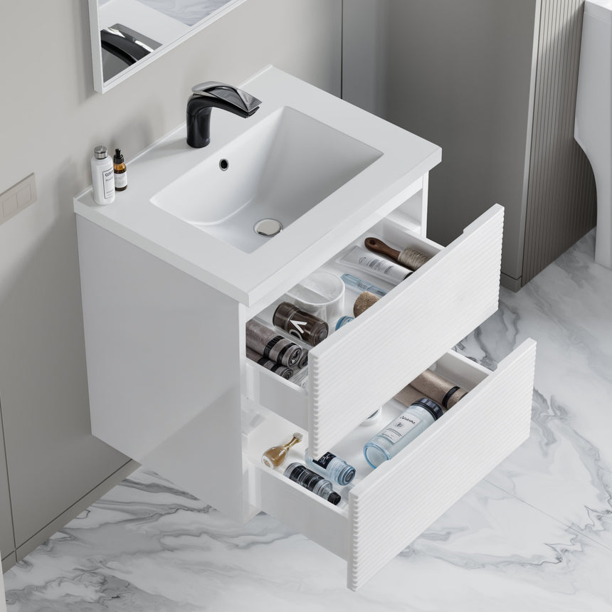Bathroom vanity with wooden finish and white countertop against a gray wall.