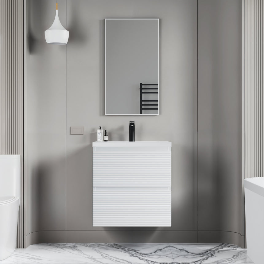 Bathroom vanity with wooden finish and white countertop against a gray wall.