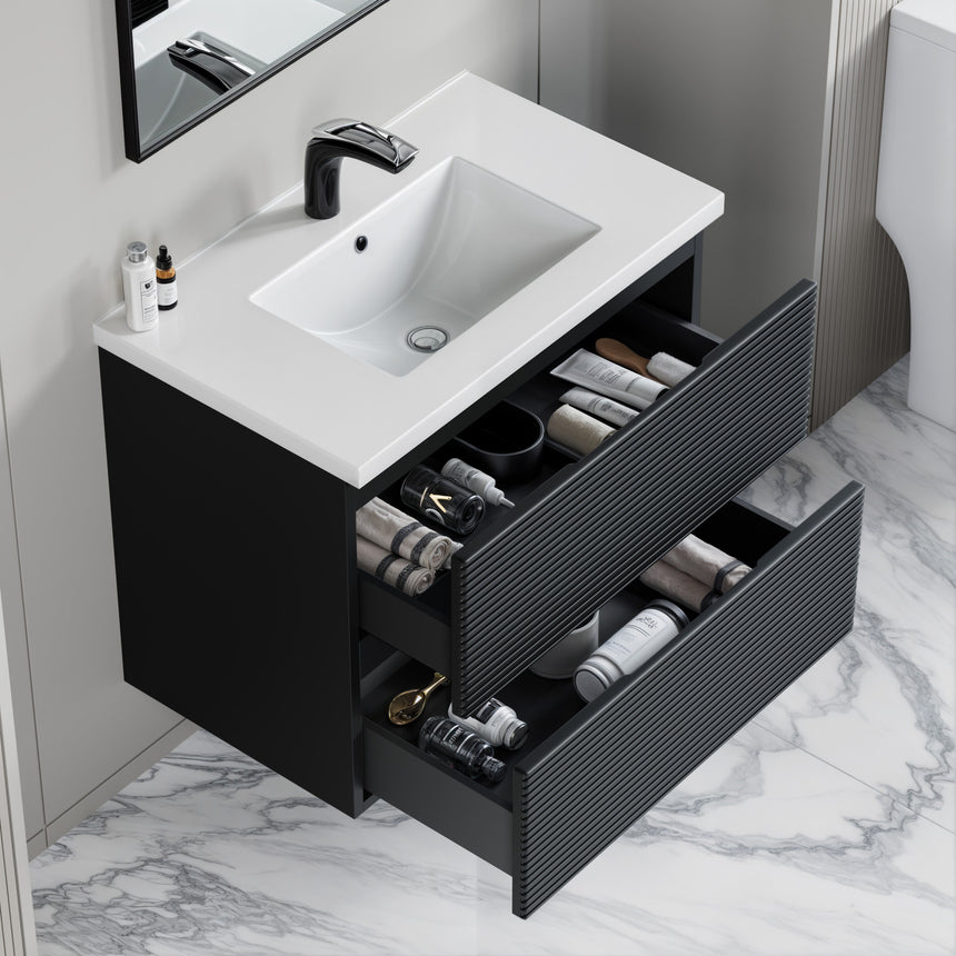Bathroom vanity with wooden finish and white countertop against a gray wall.