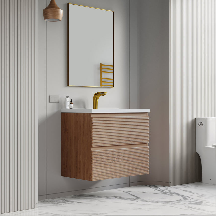 Bathroom vanity with wooden finish and white countertop against a gray wall.