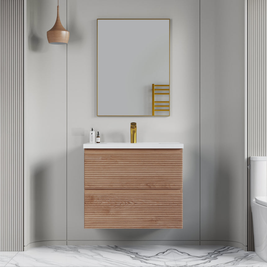Bathroom vanity with wooden finish and white countertop against a gray wall.