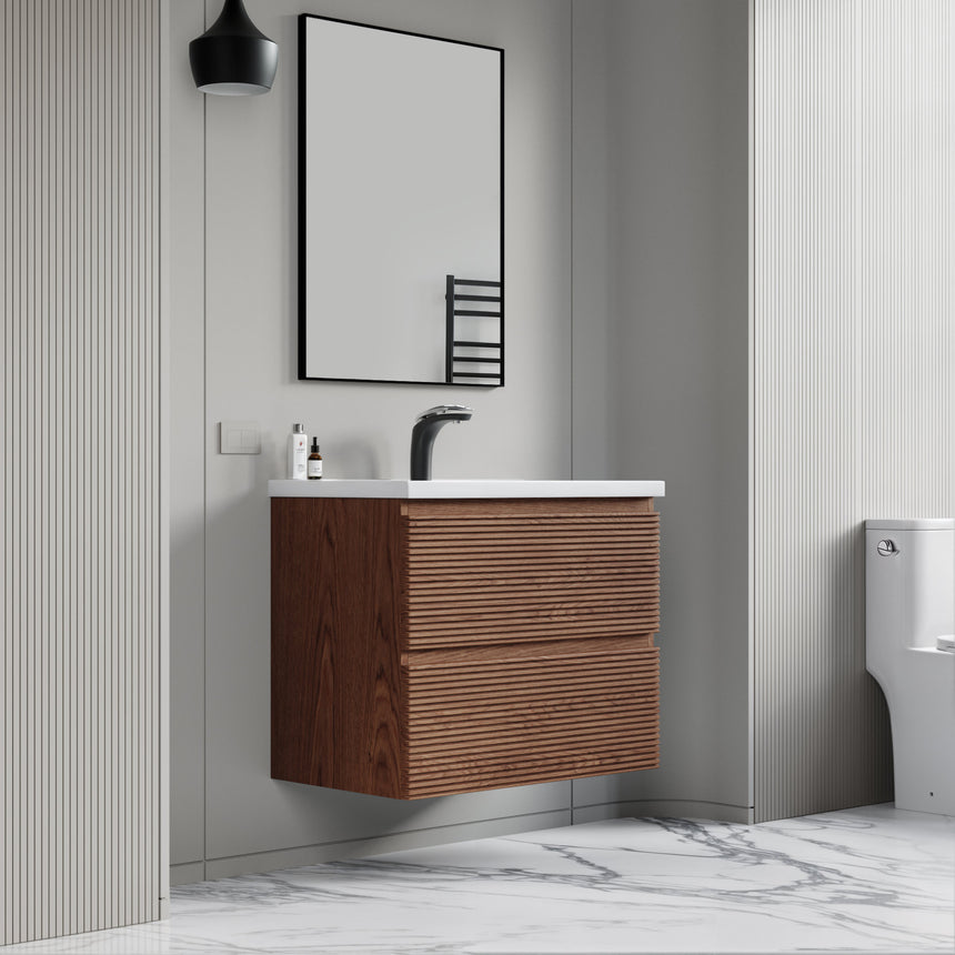 Bathroom vanity with wooden finish and white countertop against a gray wall.