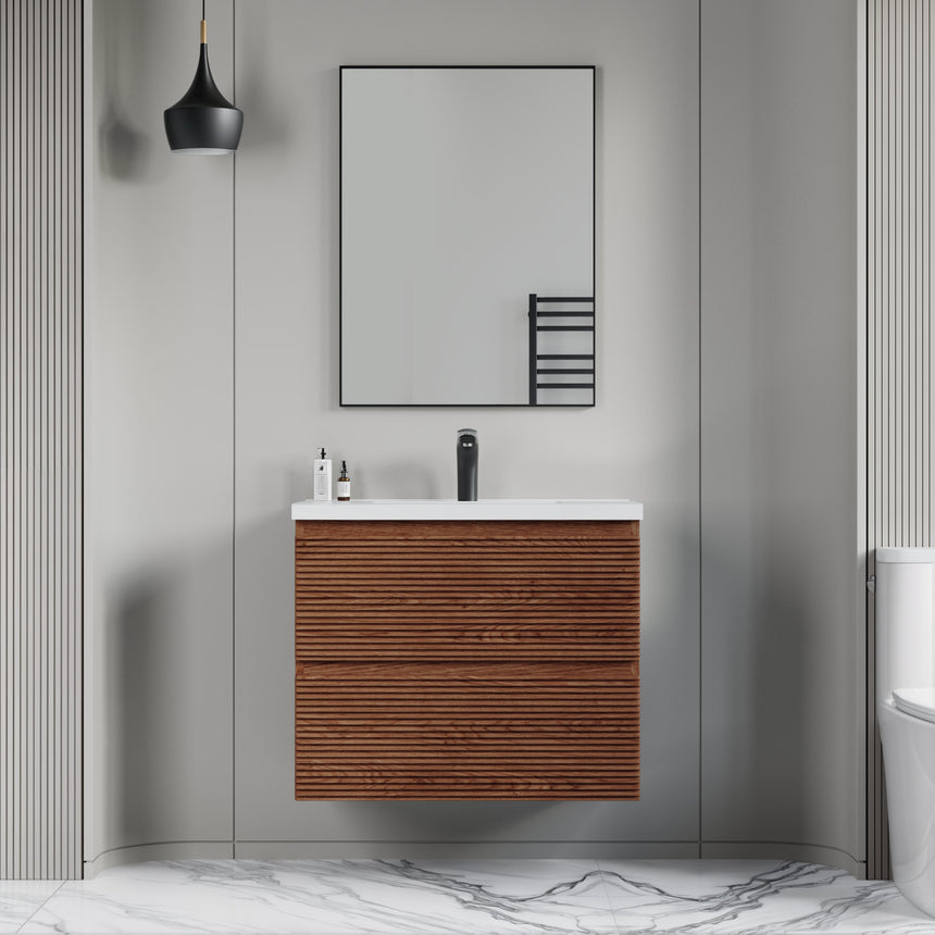 Bathroom vanity with wooden finish and white countertop against a gray wall.