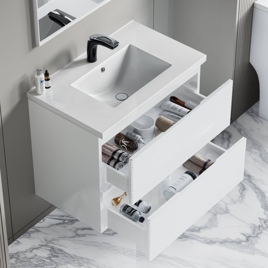 Bathroom vanity with wooden finish and white countertop against a gray wall.