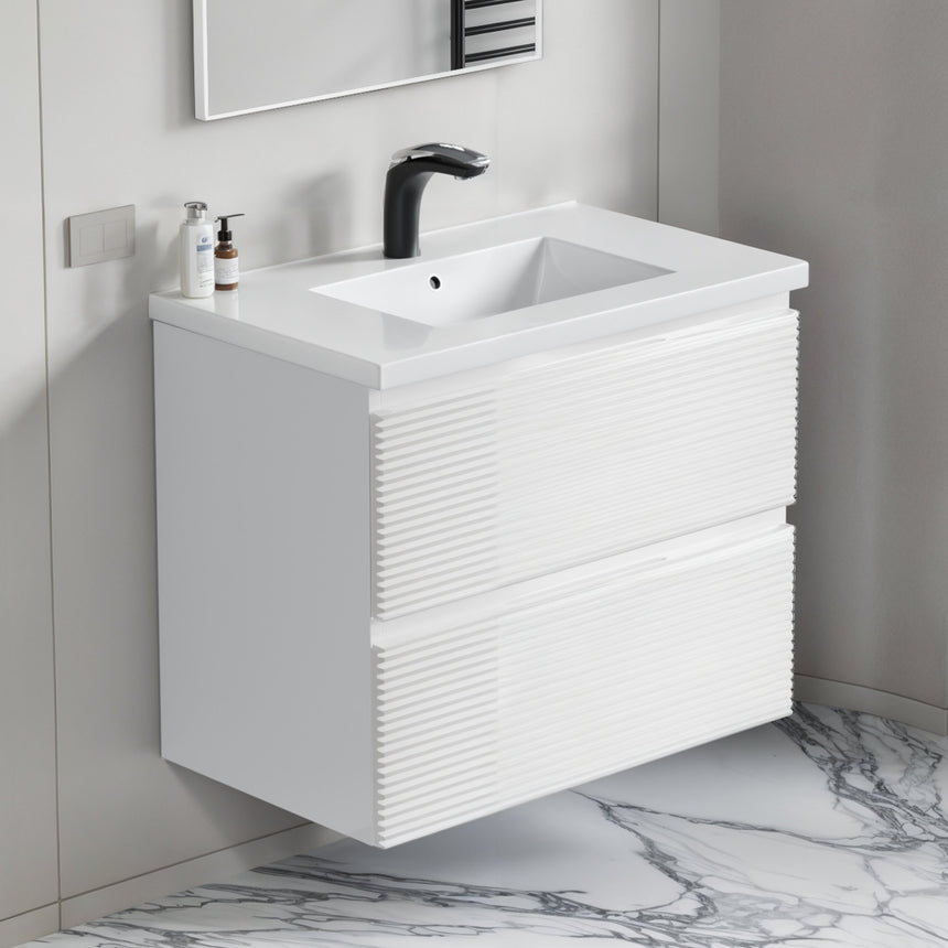 Bathroom vanity with wooden finish and white countertop against a gray wall.