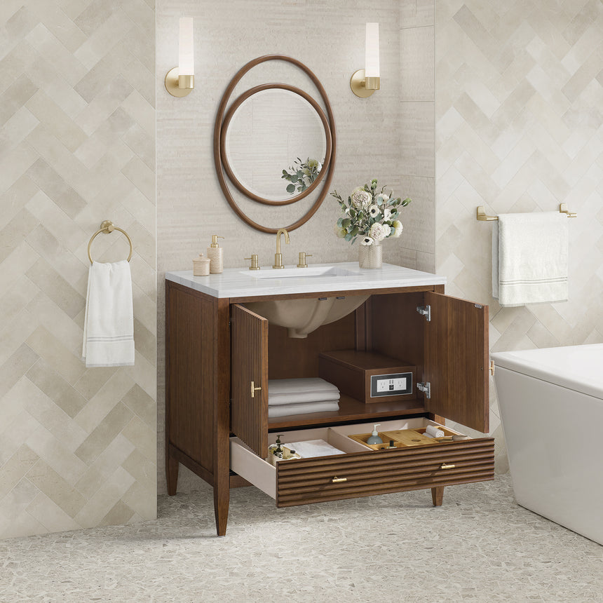 White bathroom vanity with marble countertop and decorative flowers in a bathroom setting.