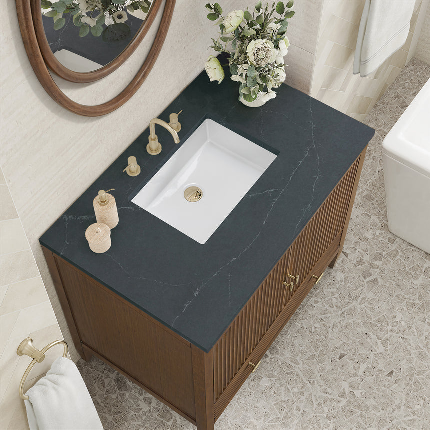 White bathroom vanity with marble countertop and decorative flowers in a bathroom setting.