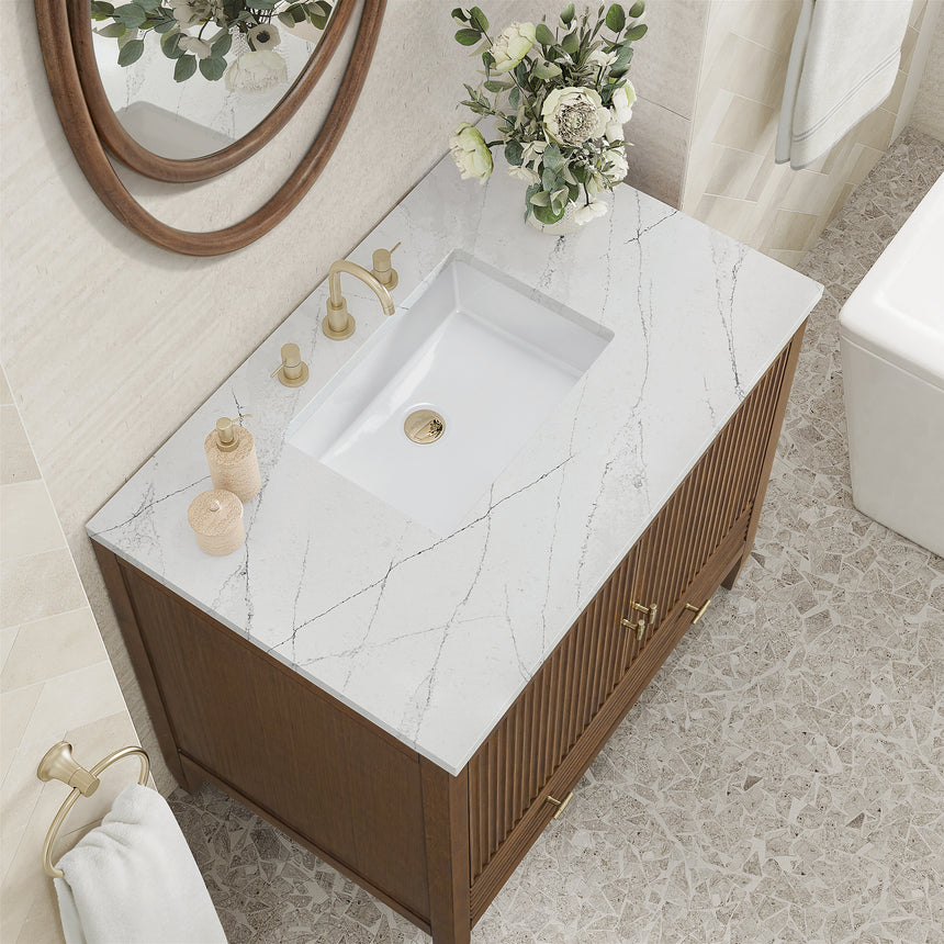 White bathroom vanity with marble countertop and decorative flowers in a bathroom setting.