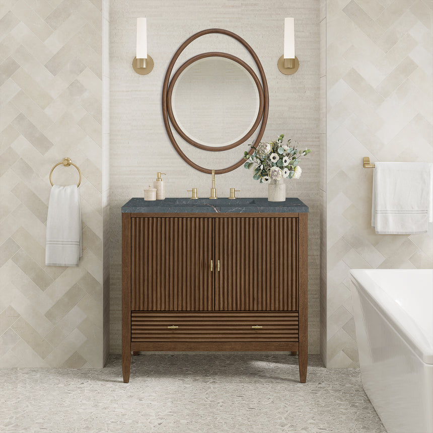 White bathroom vanity with marble countertop and decorative flowers in a bathroom setting.