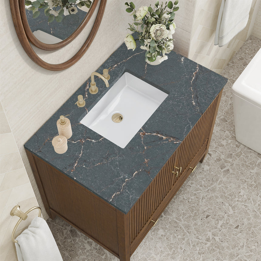 White bathroom vanity with marble countertop and decorative flowers in a bathroom setting.
