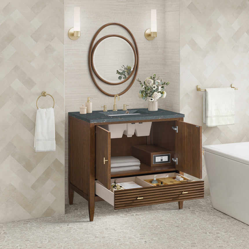 White bathroom vanity with marble countertop and decorative flowers in a bathroom setting.