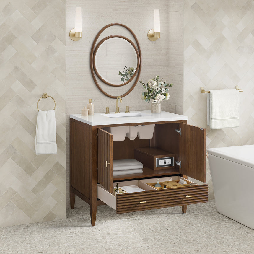 White bathroom vanity with marble countertop and decorative flowers in a bathroom setting.