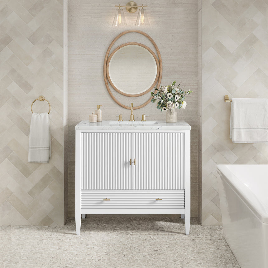 White bathroom vanity with marble countertop and decorative flowers in a bathroom setting.