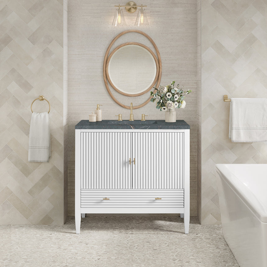 White bathroom vanity with marble countertop and decorative flowers in a bathroom setting.