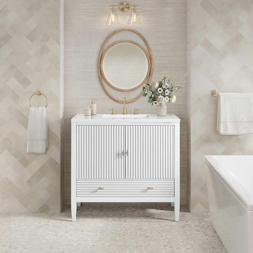 White bathroom vanity with marble countertop and decorative flowers in a bathroom setting.