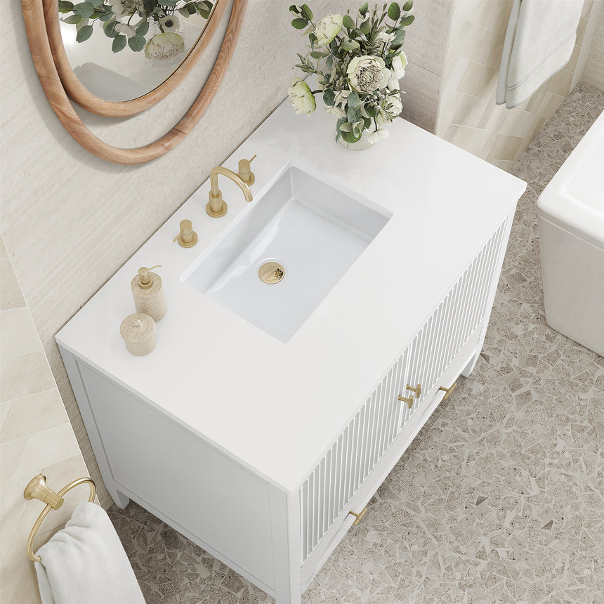 White bathroom vanity with marble countertop and decorative flowers in a bathroom setting.