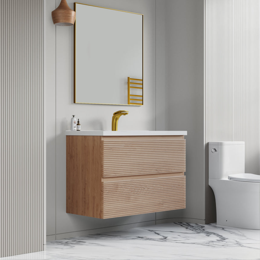 Bathroom vanity with wooden finish and white countertop against a gray wall.