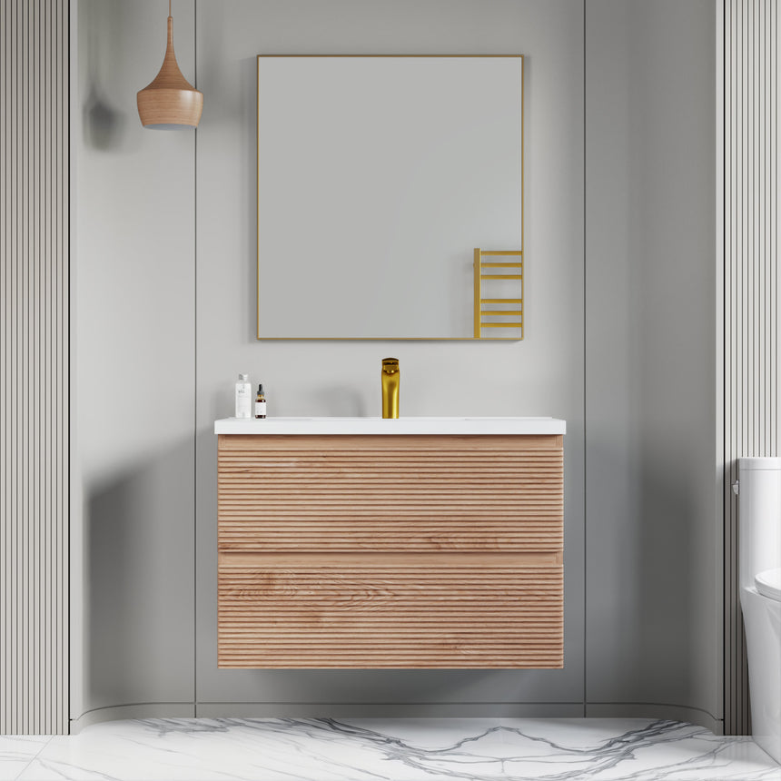 Bathroom vanity with wooden finish and white countertop against a gray wall.