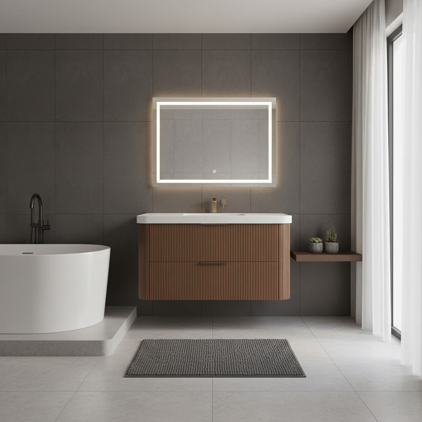 Modern bathroom with wooden vanity, freestanding bathtub, and shower area.