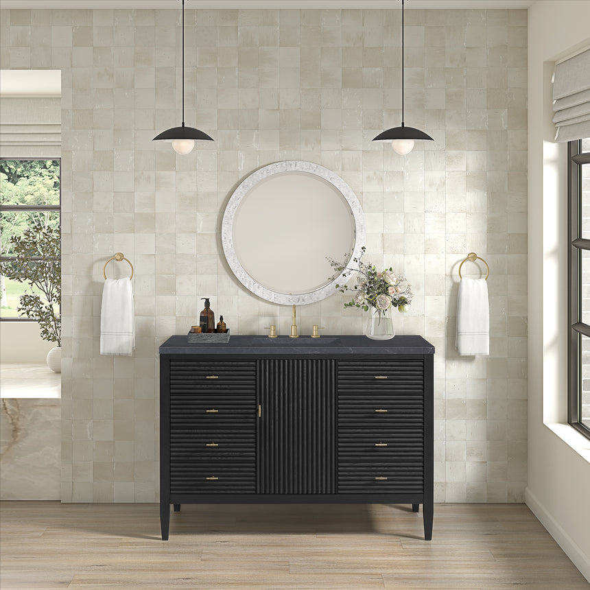White bathroom vanity with marble countertop and decorative flowers in a bathroom setting.