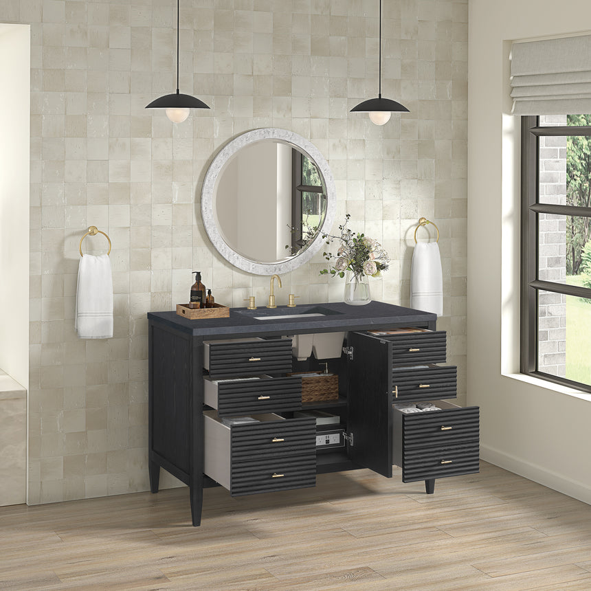 White bathroom vanity with marble countertop and decorative flowers in a bathroom setting.