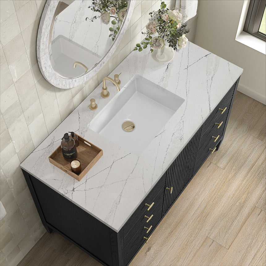 White bathroom vanity with marble countertop and decorative flowers in a bathroom setting.