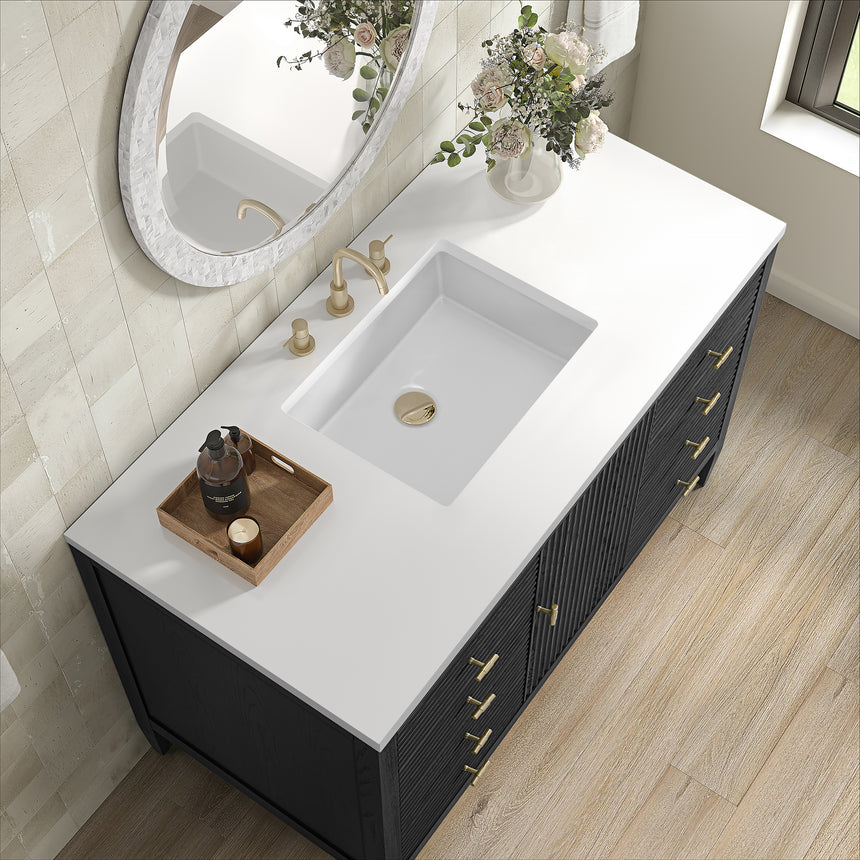 White bathroom vanity with marble countertop and decorative flowers in a bathroom setting.