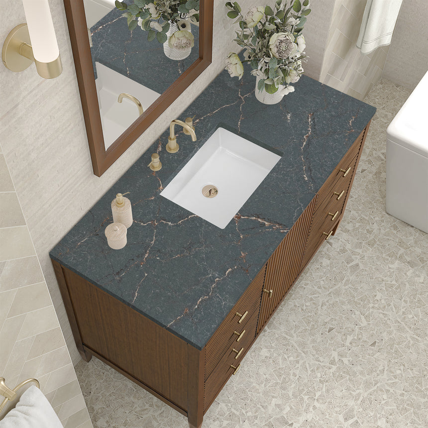 White bathroom vanity with marble countertop and decorative flowers in a bathroom setting.