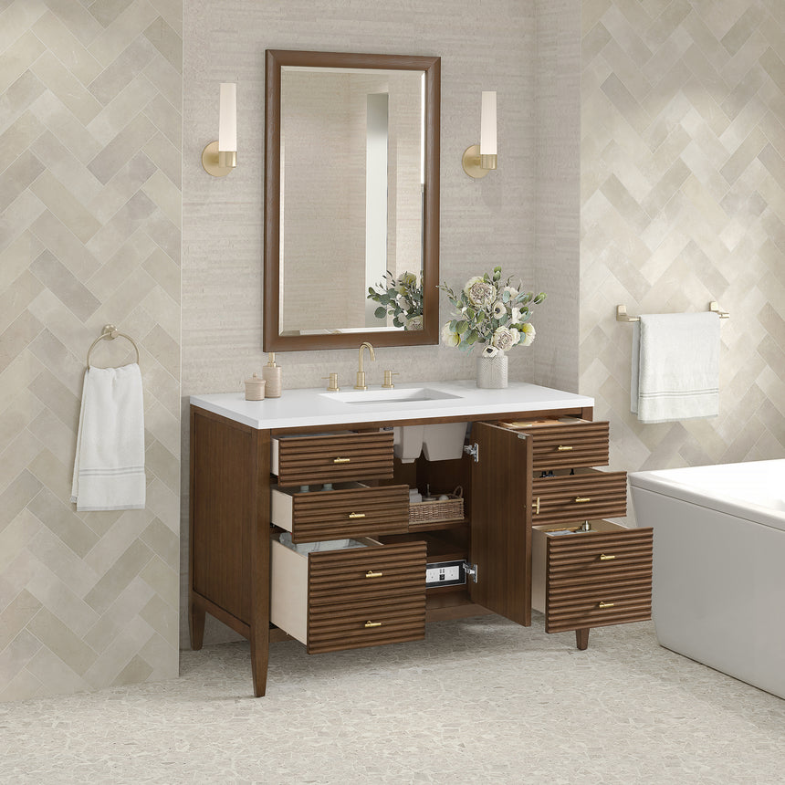 White bathroom vanity with marble countertop and decorative flowers in a bathroom setting.