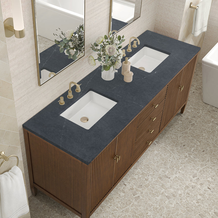 White bathroom vanity with marble countertop and decorative flowers in a bathroom setting.
