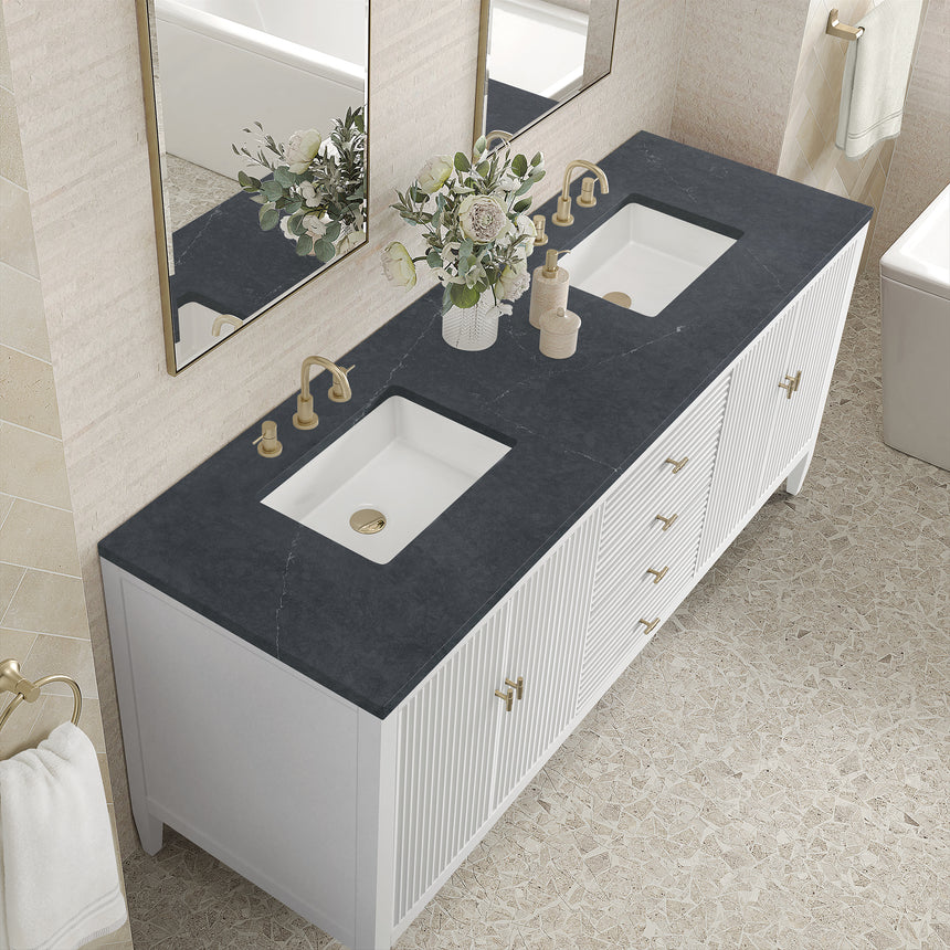 White bathroom vanity with marble countertop and decorative flowers in a bathroom setting.