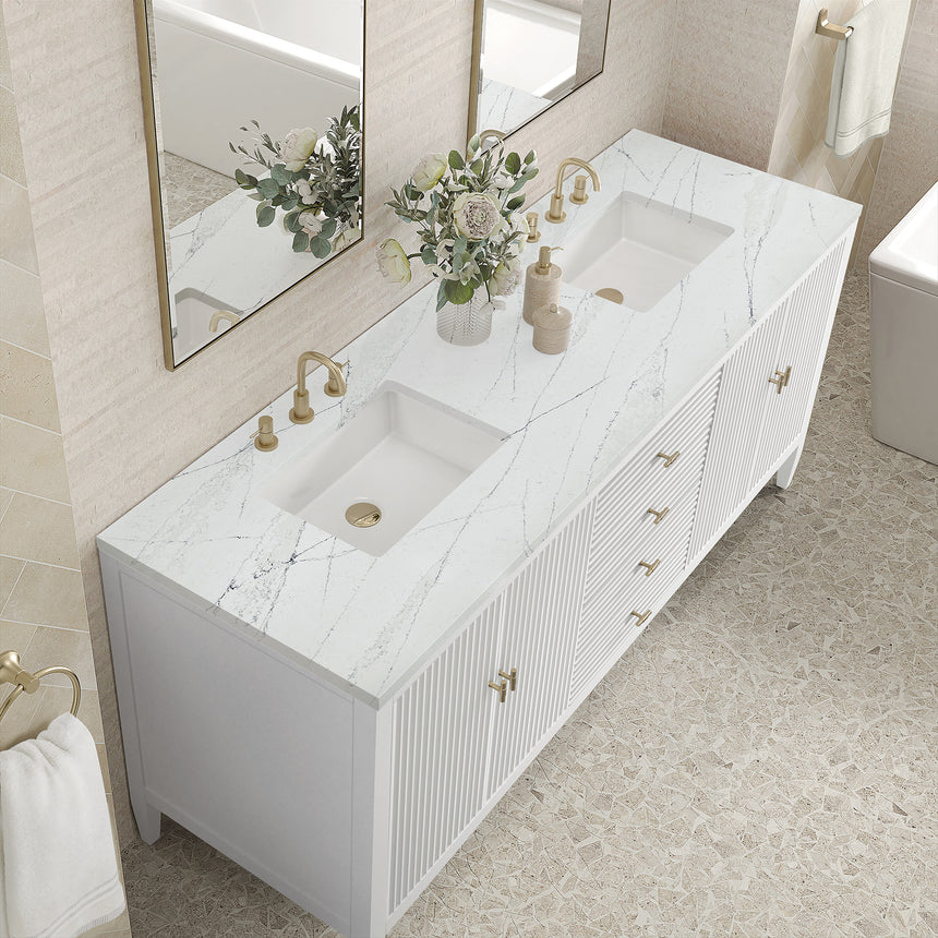 White bathroom vanity with marble countertop and decorative flowers in a bathroom setting.