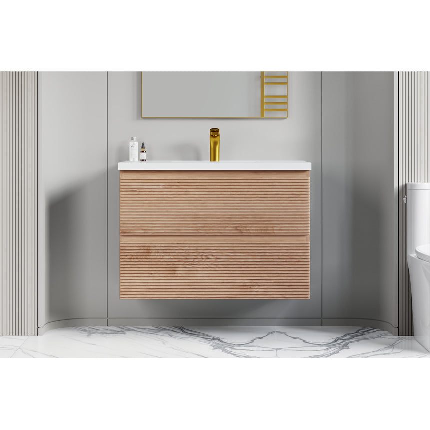Bathroom vanity with wooden finish and white countertop against a gray wall.