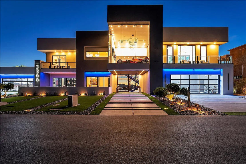 Modern luxury home exterior at sunset in Tucson Arizona with city and mountain views