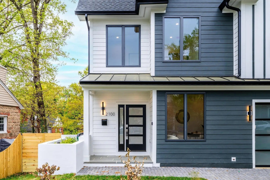 Front entry of modern Arlington VA 22204 home with black framed windows and modern glass door.