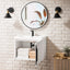 Bathroom with white brick wall, round mirror, and white floating vanity.