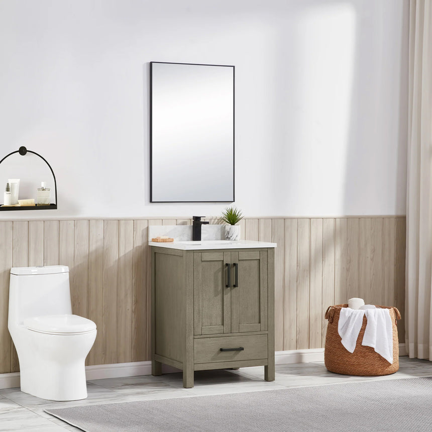 Bathroom vanity with wooden cabinets and white countertop, featuring a toilet and towel on the side.
