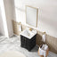 Bathroom with black vanity, white sink, and gold fixtures.