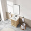 Bathroom with wooden vanity, white sink, and mirror above.