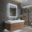 Bathroom vanity with illuminated mirror, sink, and wooden cabinets.