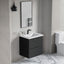 Bathroom with black vanity unit, white sink, and mirror.